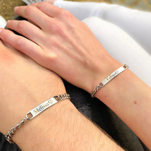 
                  
                    Man and woman showing off the Couples Engraved Bracelet Set on their hands
                  
                